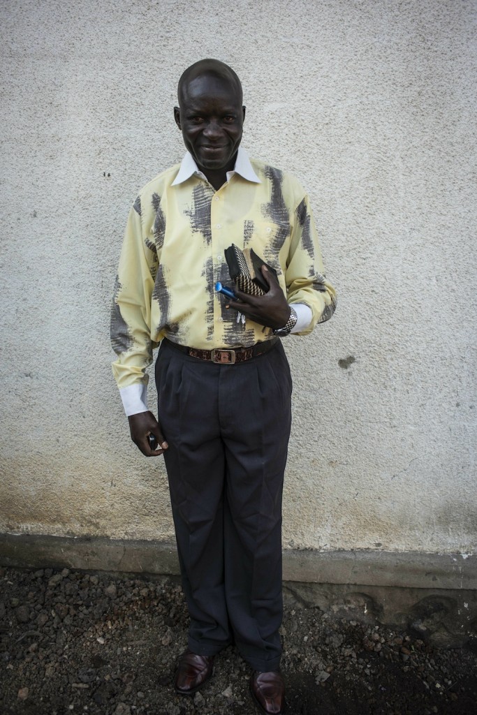 George, a local elder, holds a Bible.