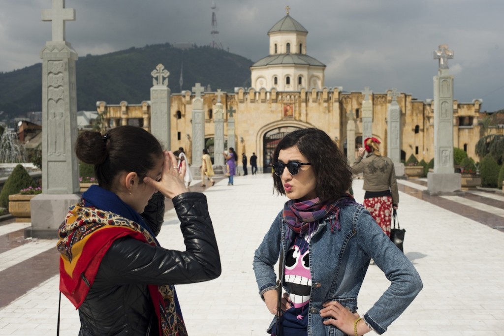 Salome Kikvadze (L) meets her friend Salome Sukishvili in a courtyard after the Trinity Church service in Tbilisi, Georgia on April 27, 2014. Both young women consider themselves devout followers of the Orthodox Church, but work in quite modern professions: Kikvadze is studying to be a doctor, and Sukishvili works at a television station.