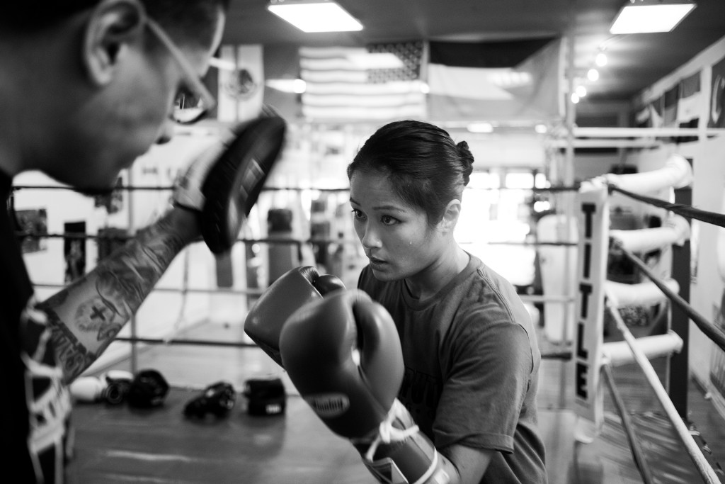 Jairo Escobar, Casey's full-time coach, spars with Casey in the ring to improve her strategy and work on some new boxing techniques at World Class Boxing Gym in San Francisco, CA.