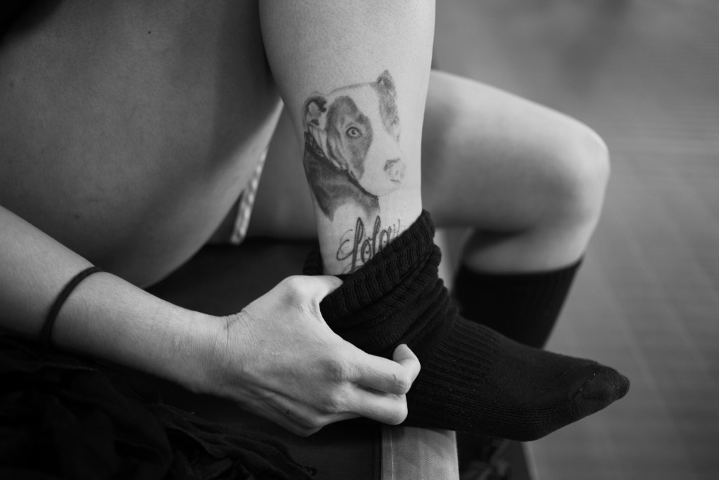 Casey takes a moment to re-adjust her sock, exposing her tattoo of her beloved dog Lola, who still lives in Hawaii.