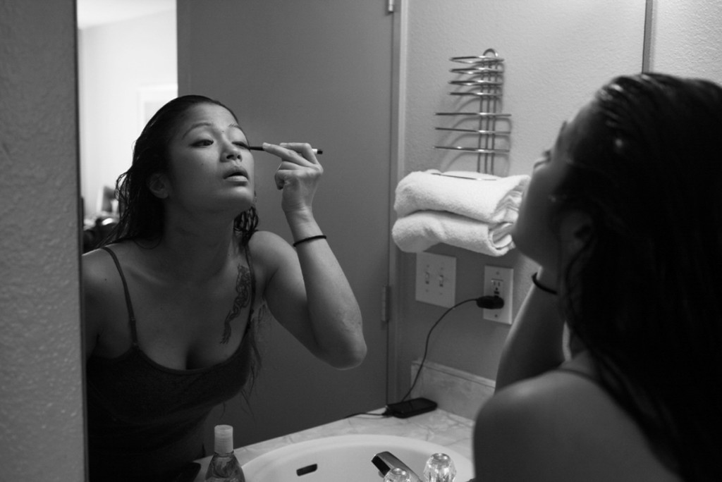 Some last minute eye-liner is applied before Casey leaves her hotel room to prepare for her pro-debut fight.