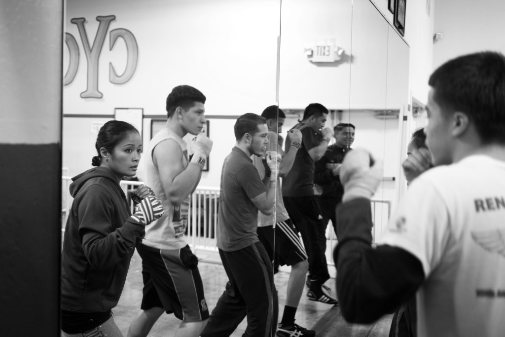 Casey practices warming-up with teenage male fighters she trains once a week at her boxing class at the Community Youth Center in Concord, CA.